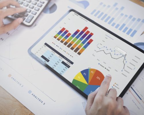 Businesswoman using a tablet to analysis graph company finance s Businesswoman using a tablet to analysis graph company finance strategy statistics success concept and planning for future in office room.